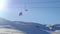 Fast motion of moving chair lift and sportive people snowboarding from snowy mountain