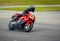 Fast motorbike racing on the race track at high speed.