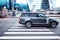Fast moving gray Range Rover L405 on city road. Overspeed in city concept. Premium SUV car on crosswalk in motion, side view