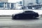 Fast moving Mercedes c-class W205 rides on a winter city road. A car on wet slippery street in motion. Overspeed in city concept