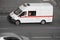 Fast moving white ambulance car on the street. Motion city street scene with white emergency vehicle without lettering for your