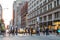 Fast paced street scene with people walking across intersection in New York City