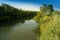 A fast river pisuerga with abundant vegetation on its banks