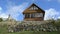 Fast rural wooden summer house stone hill cloud flow blue sky