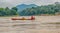 A fast sand boat races down the Mekong River
