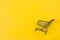 Fast shopping cart on yellow background with copy space for text