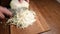 Fast shredding of white cabbage head on wooden cutting board
