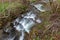 A fast stream in mountainous terrain. Water flowing in the river shown in a long exposure.