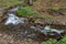 A fast stream in mountainous terrain. Water flowing in the river shown in a long exposure.