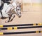 A fast white racehorse with a rider in the saddle jumps over the yellow-black barrier at a show jumping competition