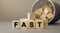 FAST - word concept from wooden blocks on desk