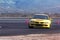Fast Yellow car make turn on race track