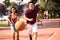 He is fast. Young couple playing basketball. Focus is on woman and man