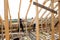 Fasteners and installation of roof rafters by workers. Preparation for laying slate. Construction and installation carpentry work