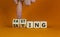 Fasting or eating symbol. Doctor turns wooden cubes and changes the word `eating` to `fasting`. Beautiful orange background, c