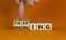 Fasting or starving symbol. Doctor turns wooden cubes and changes the word `starving` to `fasting`. Beautiful orange backgroun