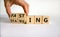 Fasting or starving symbol. Doctor turns wooden cubes and changes the word `starving` to `fasting`. Beautiful white background