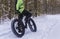 Fat bike also called fat bike or fat-tire bike - Cycling on large wheels in the winter forest.