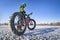 Fat bike cyclist on a frozen lake in winter