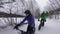 Fat bike in winter. Fat biker riding bicycle in the snow in winter. Selfie video by woman and couple living healthy