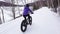 Fat bike in winter. Fat biker riding bicycle in the snow in winter. Woman living healthy outdoor active winter sports