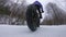 Fat bike in winter. Woman fat biker riding bicycle in the snow in winter. Close up action shot of fat tire bike wheels