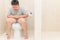 Fat boy suffer stomach and sit in toilet,