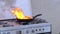 Fat burning in pan on a stove in the kitchen, kitchenfire demonstration