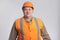 Fat construction worker in funny confusion in hard hat and reflective vest, bulder does not understand and showing comic face