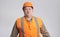 Fat construction worker in funny confusion in helmet on grey background, bulder does not understand with humorous face expression