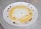 Fat on a dirty white plate after eating. Dish cleaner, anti-grease, dish care. Close-up