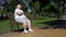 Fat girl exhausted after jogging takes minute rest on bench, combating obesity