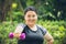 fat girl happy smile with dumbbell sport outdoor exercise