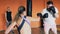 Fat guy and slender girl fight in boxing gloves. Individual weight loss drills for thick male. Training with personal