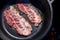 Fat juicy bacon strips frying in its own grease