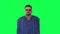 Fat man in blue suit and smokey glasses speaking front view on green screen