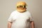 Fat man with burger head wearing a t-shirt. Concept of fast food, unhealthy eating, appetite, surreal art, and humor