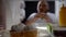 Fat man eating burger in front of fridge, junk food addiction, cupcakes closeup