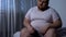 Fat man feels heaviness and pain in stomach, abdominal bloating, indigestion