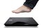 Fat man feet stepping on the weighing scale