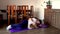 Fat man and pomeranian dog doing gymnastics at home on mat. Overweight guy and funny dog doing yoga exercises at home