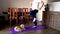 Fat man and pomeranian dog doing gymnastics for losing weight at home on mat on floor. Doing fitness with your dog. Overweight guy