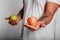 Fat man on a white background with an apple in his hands. man chose a healthy lifestyle.