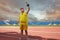 A fat man with a winner`s cup in his hands at the stadium.