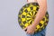 Fat people holding round yellow dartboard beside his belly position. Target of losing weight concept. Studio shot  on grey