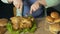 Fat woman carving roughly roast chicken with fork and knife, eating junk food