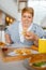 Fat woman eating high calorie food in mall