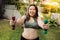 Fat woman happy fun face exercise weight loss concept at home with lift dumbbell
