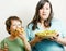 Fat woman holding salad and little cute boy with hamburger teasing, real family on white eating food