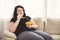 Fat woman overeating junk food. sedentariness